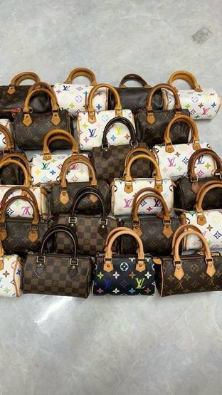 Rows of Louis Vuitton Speedy bags in different conditions