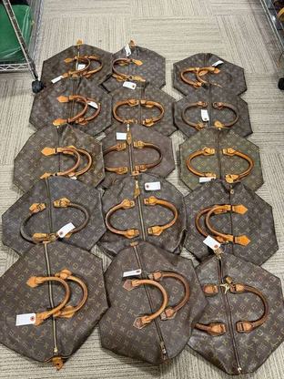 Louis Vuitton bags laid out with inspection tags