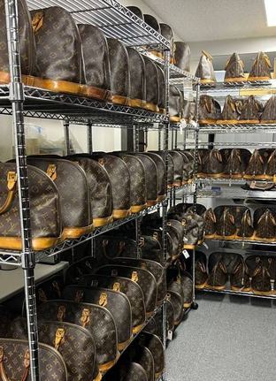 Warehouse shelves full of Louis Vuitton bags