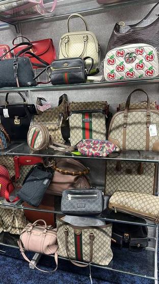 Shop display of Gucci bags on glass shelves